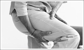 woman holding leg pain sciatica