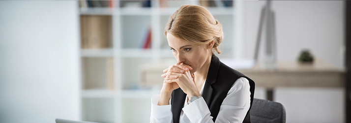 Stressed Woman Sitting At Desk Having a Mood Swing