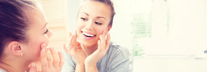 Smiling woman with clear skin after functional medicine acne treatment