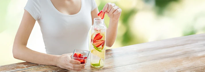 Woman preparing detox water representing functional medicine heavy metal cleansing Woman preparing detox water representing functional medicine heavy metal cleansing