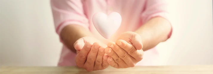 Hands holding glowing heart symbolizing compassionate functional medicine insurance options