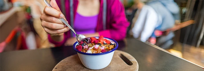 Woman eating nutritious meal representing functional medicine dietary guidance