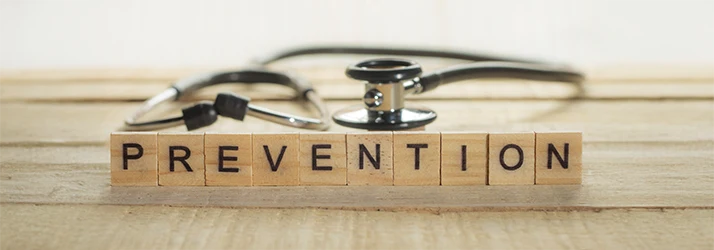 Stethoscope and wooden blocks spelling prevention, emphasizing functional medicine preventative care