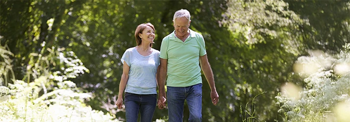 Happy older couple enjoying outdoor wellness after functional medicine treatment