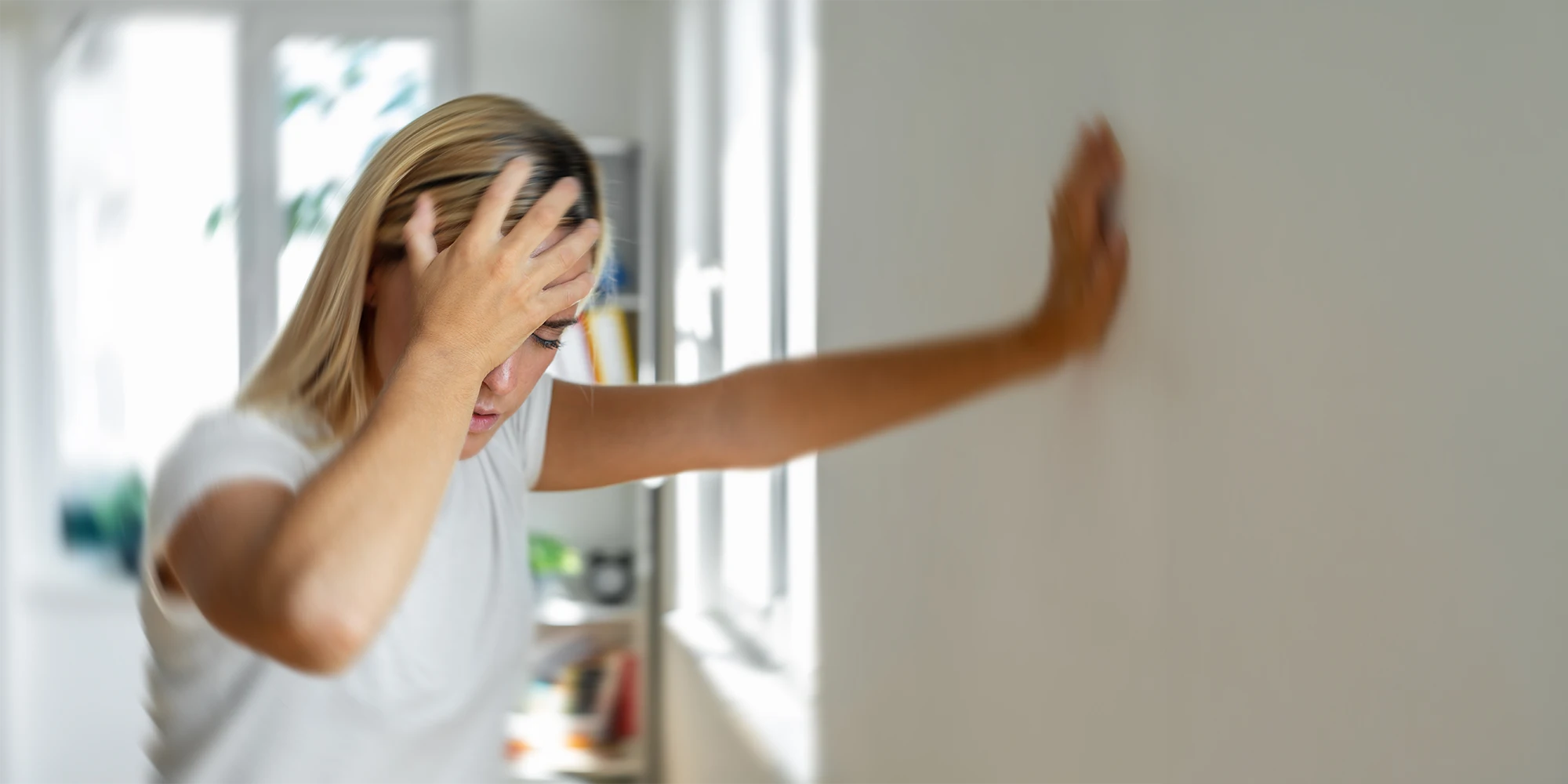 Woman-Clutching-Her-Head-and-Steadying-Herself-Seeming-Dizzy.webp